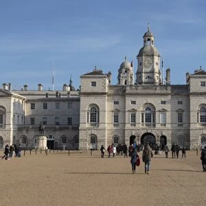 Tourists walk towards the arch of Horse Guards Parade under a winters blue sky, Whitehall, London, England, United Kingdom, Europe
