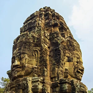 Tower with two of the 216 smiling sandstone faces at 12th century Bayon temple in