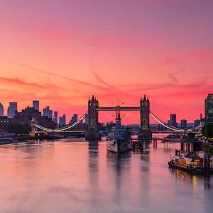 Tower Bridge, River Thames and HMS Belfast at sunrise with pink sky
