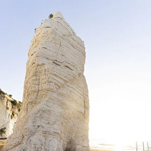 Towering white rock monolith Pizzomunno at sunrise, Vieste, Foggia province