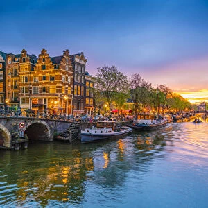 Traditional Dutch gabled houses and canal at dusk, Amsterdam, Netherlands, Europe
