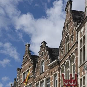 Traditional gabled facades decorated with heraldic banners, Oude Markt, Leuven, Belgium, Europe