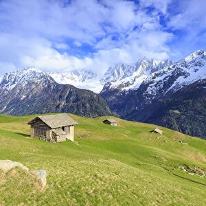 Traditional huts with Pizzo Badile in the background, Soglio, Val Bregaglia (Bregaglia Valley)