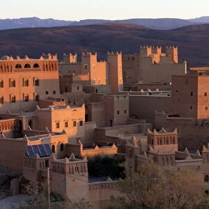 Traditional kasbahs (fortified houses) bathed in evening light in the town of Nkob, near the Jbel Sarhro mountains, Morocco, North Africa, Africa