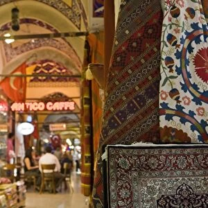 Traditional rugs with cafe in the background, Grand Bazaar, Istanbul, Turkey, Europe