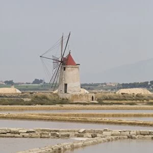 Traditional sea salt beds and windmill, Mozia, Sicily, Italy, Europe
