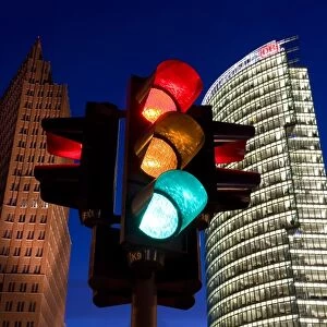 Traffic signal and office buildings illuminated at