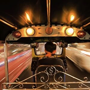 Tuk-tuk (auto rickshaw) in motion at night, Bangkok, Thailand, Southeast Asia, Asia