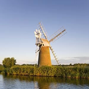 Turf Fen windmill reflected in the River Ant at sunrise, Norfolk Broads