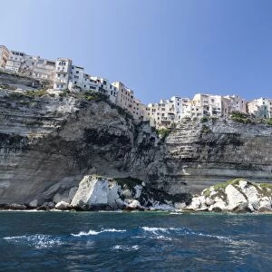 The turquoise sea frames the ancient village perched on the white cliffs, Bonifacio