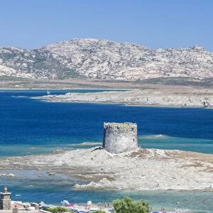 Turquoise sea and old tower surround La Pelosa Beach, Stintino, Asinara National Park
