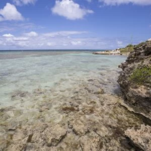 The turquoise shades of the Caribbean Sea seen from the cliffs of Green Island, Antigua and Barbuda