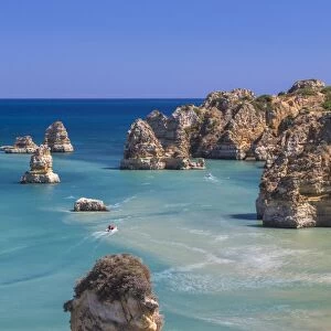 The turquoise water of the Atlantic Ocean and cliffs surrounding Praia Dona Ana beach