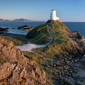Twr Mawr lighthouse on Llanddwyn Island backed by the Lleyn Peninsula, near Newborough, Anglesey, North Wales, United Kingdom, Europe
