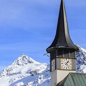 The typical alpine bell tower frames the snowy peaks, Langwies, district of Plessur