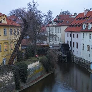 Typical houses on water canal frame the old mill of Certovka, Lesser Quarter, Prague
