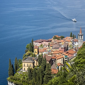 The typical village of Varenna surrounded by the blue water of Lake Como and gardens