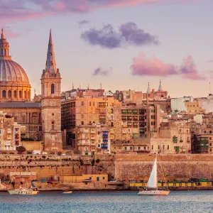 Valletta skyline at sunset with the Carmelite Church dome and St. Pauls Anglican Cathedral, Valletta, Malta, Mediterranean, Europe