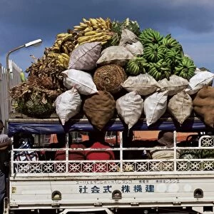 Van loaded with bananas on its roof leaving the market, Stone Town, Zanzibar
