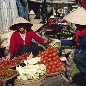 Vegetables and pineapples on sale in free market in southern Vietnam