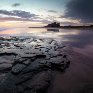 View towards Bamburgh Castle at sunrise from Bamburgh Beach, Bamburgh, Northumberland