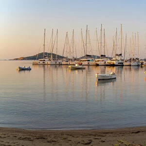 View of boats overlooking Skiathos Town at sunrise, Skiathos Island, Sporades Islands, Greek Islands, Greece, Europe