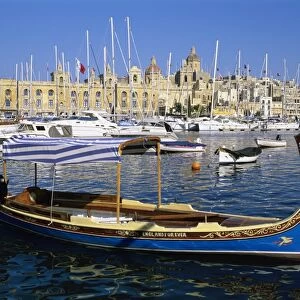 View across Dockyard Creek to Maritime Museum on Vittoriosa with traditional boat