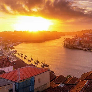 View of the Dom Luis I bridge over Douro River aligned with colourful buildings at sunset, UNESCO World Heritage Site, Porto, Norte, Portugal, Europe