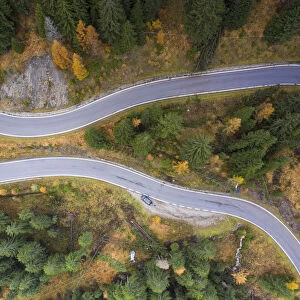 A view by drone of a winding road in the Dolomites, Veneto, Italy, Europe