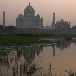 View at dusk across the Yamuna river of the Taj Mahal