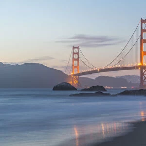 View of Golden Gate Bridge from Baker Beach at dusk, South Bay, San Francisco, California