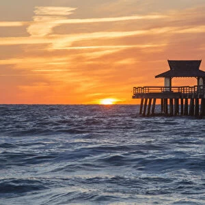 View across the Gulf of Mexico from beach beside Naples Pier, sunset