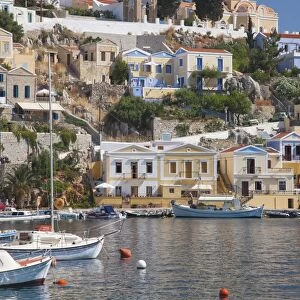 View over harbour to colourful houses and church, Gialos (Yialos), Symi (Simi), Rhodes
