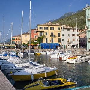 View across the harbour to colourful houses on the shore of Lake Garda