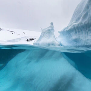 Above and below view of an iceberg at Cuverville Island, Ererra Channel, Antarctica