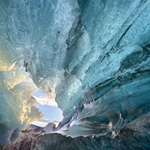 View inside an ice cave under the south Vatnajokull Glacier, captured at sunrise during winter when the ice caves are accessible, near Jokulsarlon, Southern Iceland, Iceland, Polar Regions
