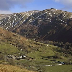 View from Kirkstone Pass showing traditional whitewashed stone farmhouse dwarfed by nearby fells