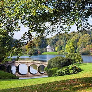 View across lake to the distant Pantheon in autumn, with Palladian bridge