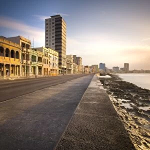 View along The Malecon at dusk showing mix of old and new buildings, Havana