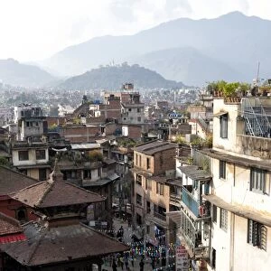 View over narrow streets and rooftops near Durbar Square towards the hilltop temple of Swayambhunath, Kathmandu