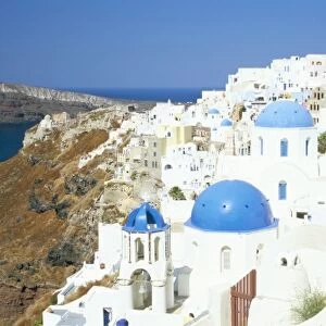 View of Oia with blue domed churches and whitewashed buildings