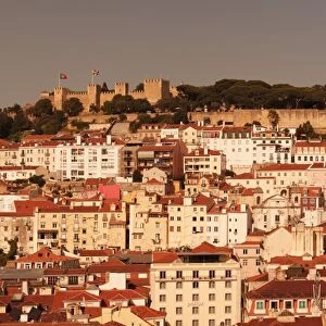 View over the old town to Castelo de Sao Jorge castle at sunset, Lisbon, Portugal, Europe