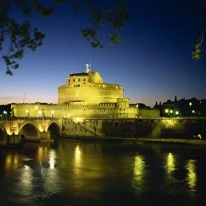 View across River Tiber to illuminated Castel Sant Angelo at dusk