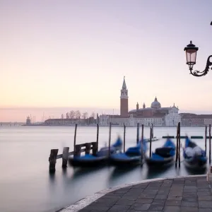 View towards San Giorgio Maggiore at dawn from Riva Degli Schiavoni, with gondolas in foreground