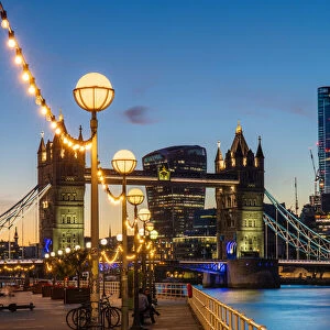 View of Tower Bridge and City of London at sunset, from Shad Thames, London, England