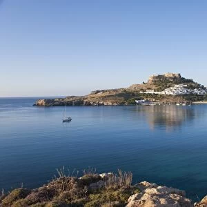 View across the tranquil waters of Lindos Bay, Lindos, Rhodes, Dodecanese Islands