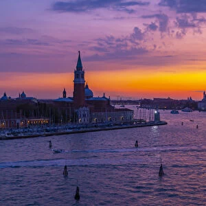View of Venice skyline and red sky from cruise ship at dusk, Venice, UNESCO World