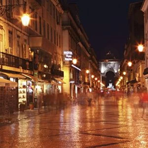Warm summers night on the cobbled Rua Augusta, leading to Arch of Rua Augusta, in the Baixa district of Lisbon, Portugal, Europe