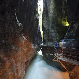 Water of creek flows in the narrow limestone gorge carved by river, Aare Gorge, Bernese Oberland