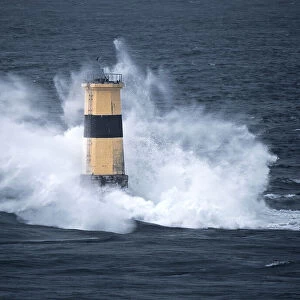 Waves crash on Tourelle de la Plate Lighthouse, Pointe du Raz, Finistere, Brittany